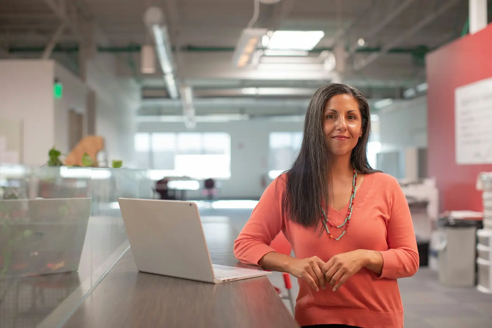 Business professional considering her next steps at an office desk
